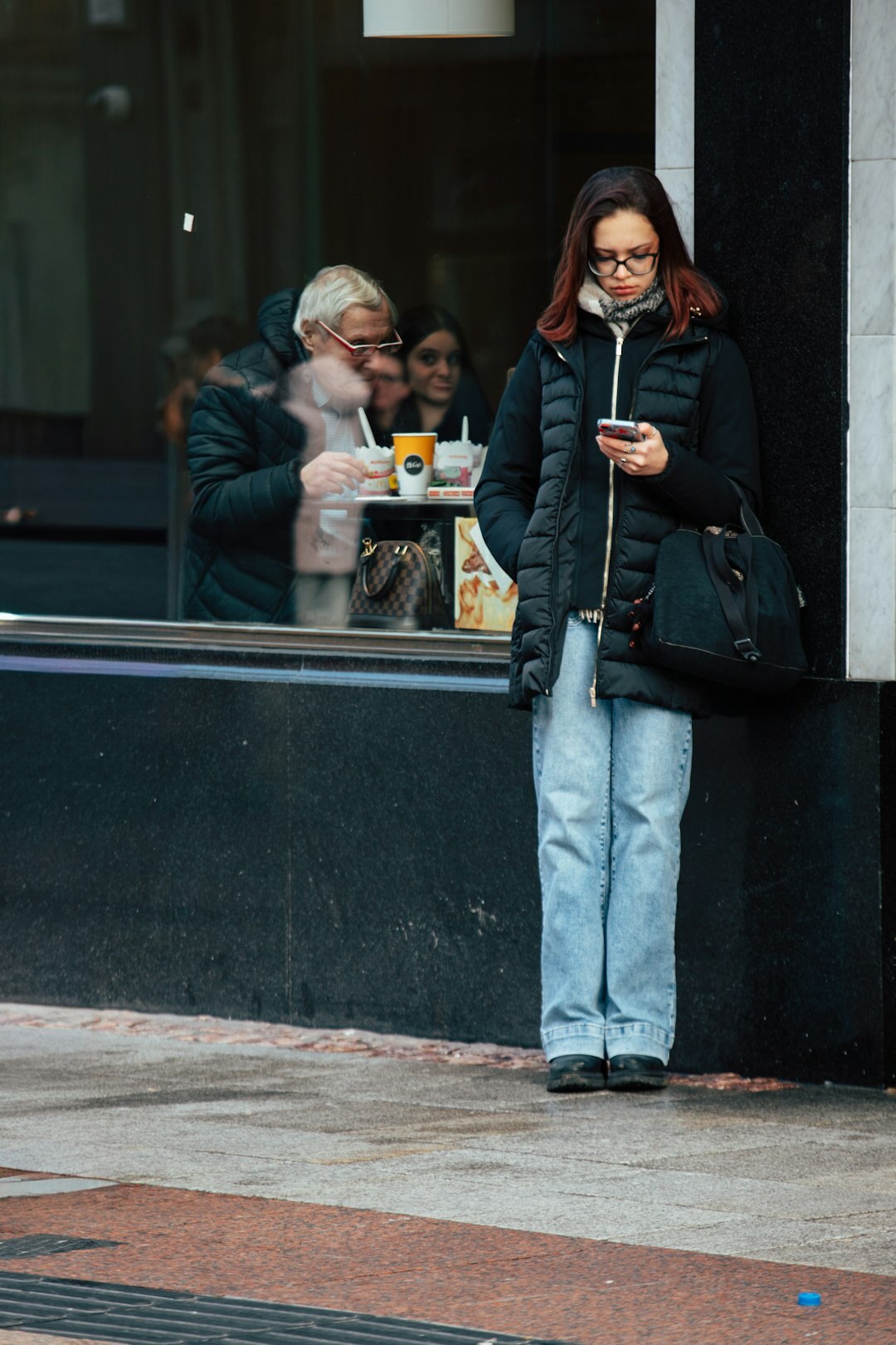 person using smartphone in cafe